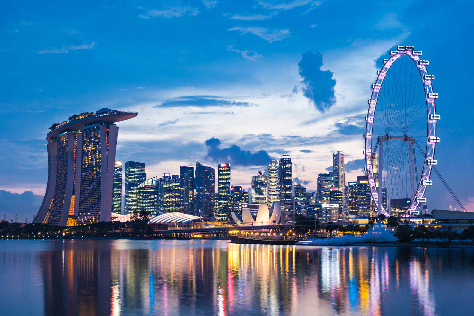 SINGAPORE - OCTOBER 16, 2014: Marina Bay Sands, Singapore Flyer and ArtScience Museum at sunset.