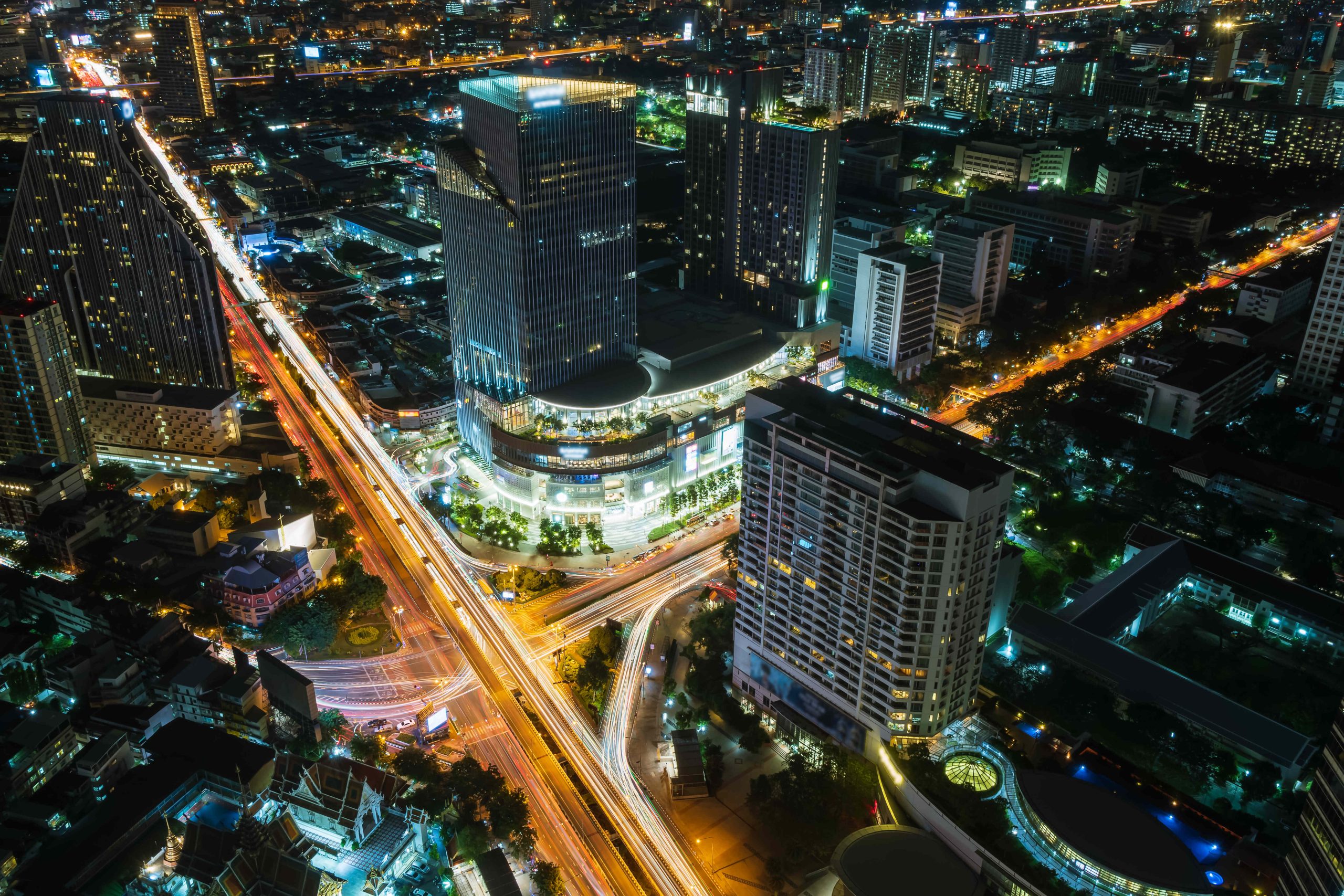 Bangkok business district city center above Samyan intersection and traffic, with buildings and skyscrapers, during night - Time Lapse