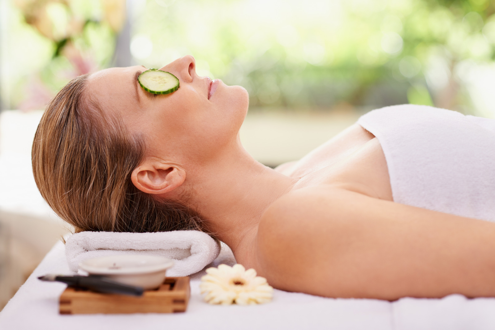 Cropped shot of a woman in a day spa relaxing on a massage table