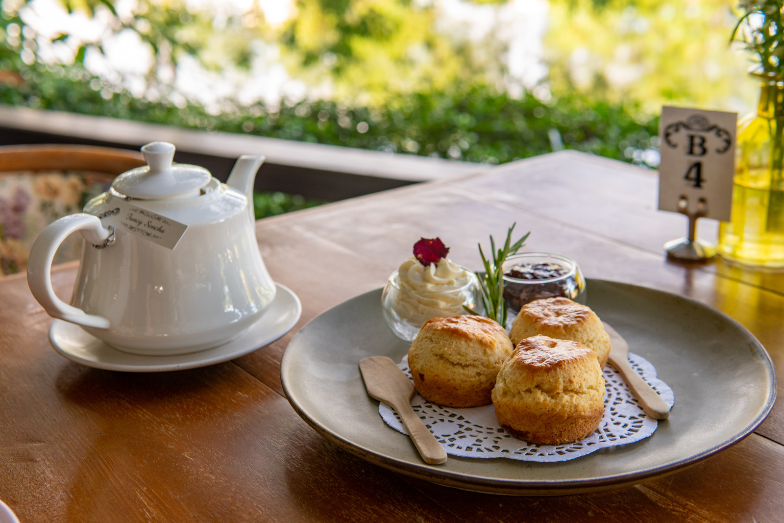 Enjoying Tea and crumpets or scones with jam and creme during High Tea